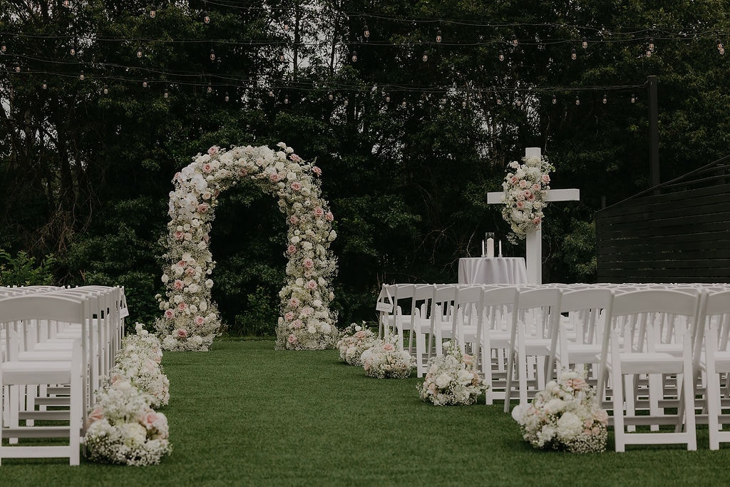 Floral arch close-up with orchids, roses, and baby's breath — White & Sable