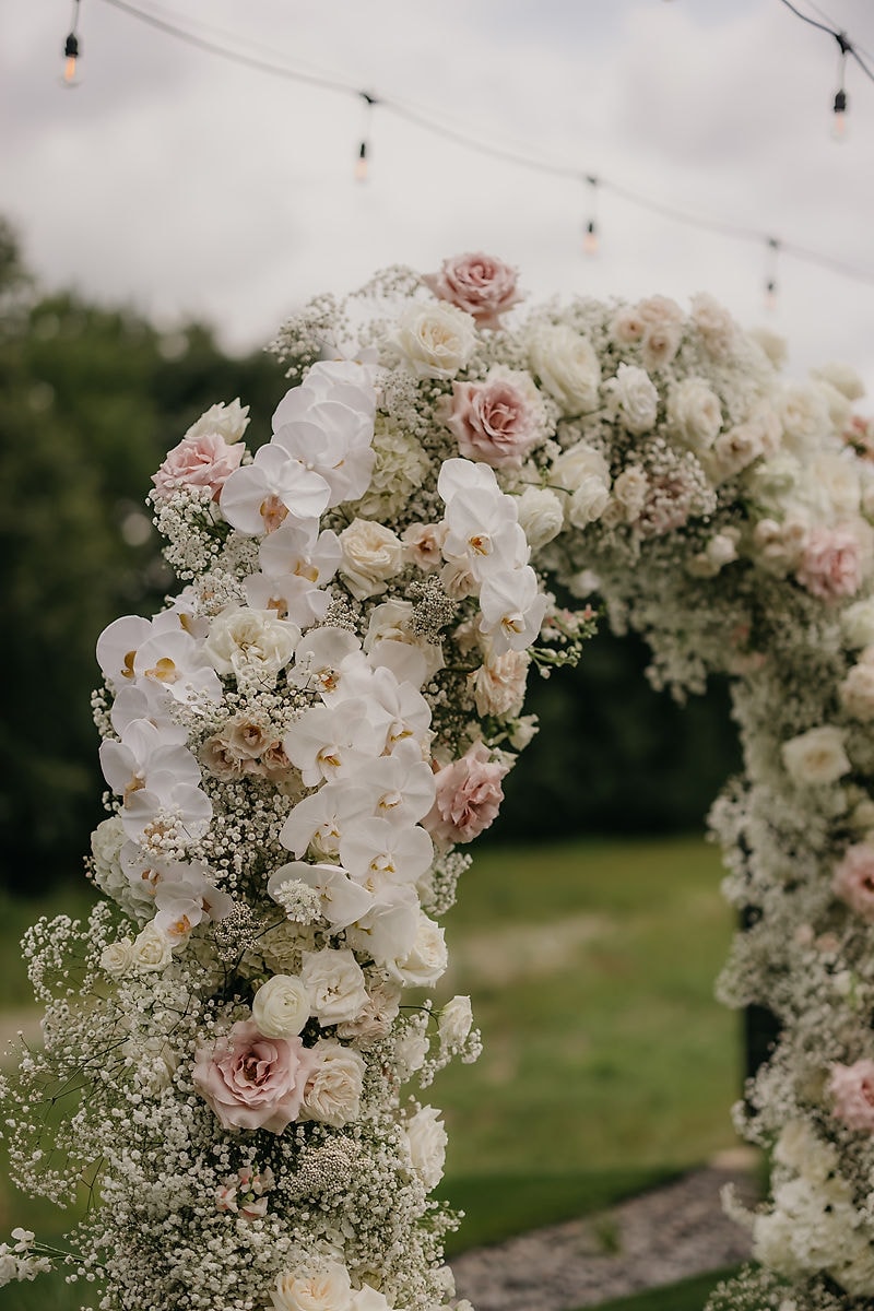 Colorful floral arch at The Hutton House wedding ceremony