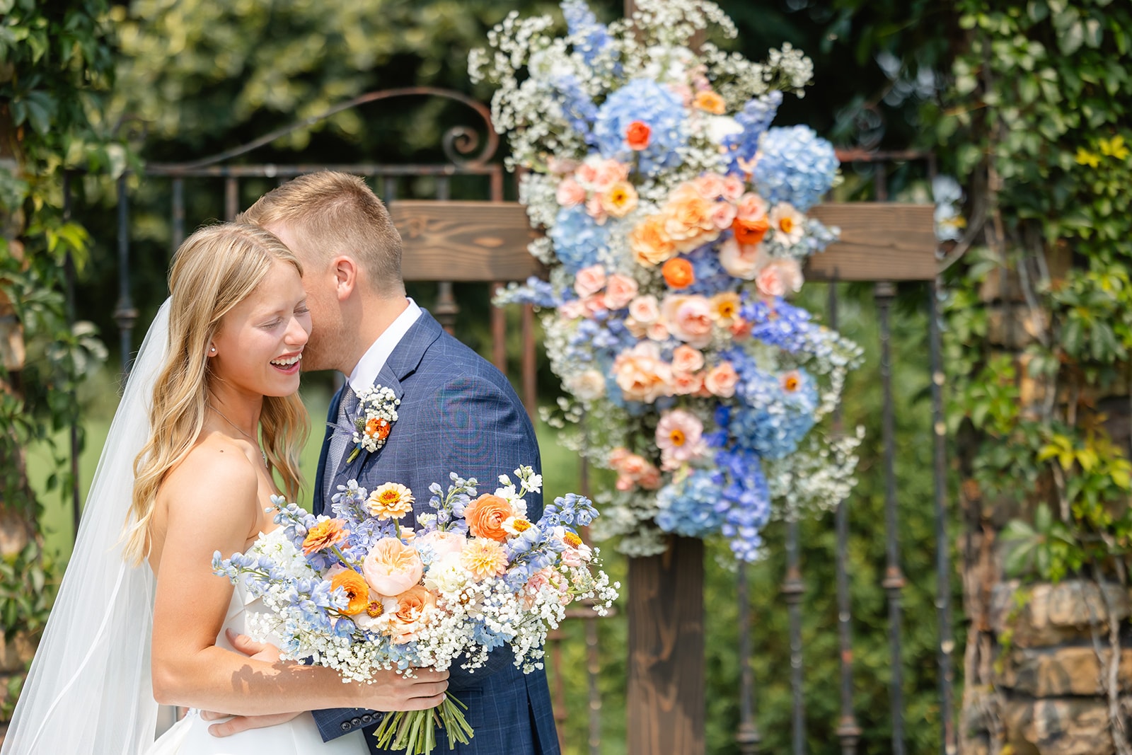 Bride and groom at wedding garden floral arch — Redeemed Farm
